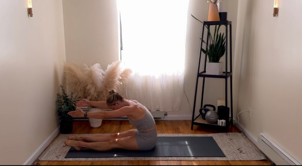 Personal trainer and Pilates instructor demonstrating the roll-up