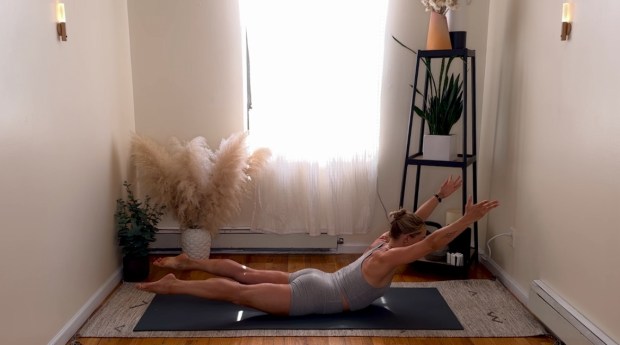 Personal trainer and Pilates instructor demonstrating spinal stretches