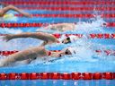 Canada's Penny Oleksiak (bottom) competes in the women's 200m freestyle final at the Tokyo 2020 Olympic Games on July 28, 2021 at the Tokyo Aquatics Center in Tokyo.