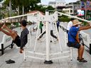 People use exercise equipment in a park on June 27, 2024 in Phnom Penh, Cambodia. 