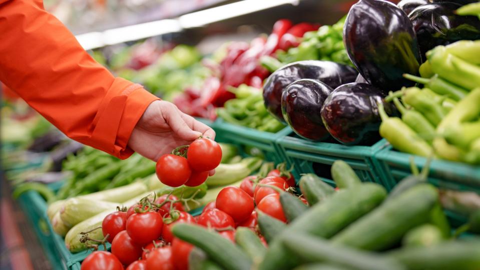 A man buys vegetables at the grocery store