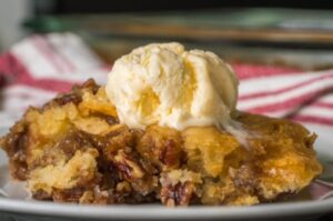 Pecan Pie Cobbler, a delicious dessert combining the classic flavors of pecan pie with a warm, buttery cobbler topping.